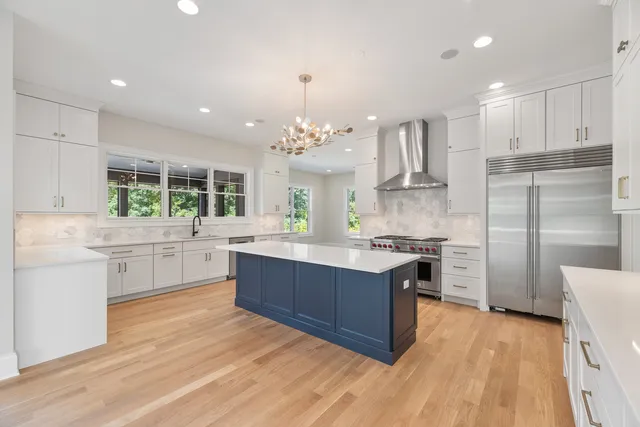 a spacious bathroom with a double vanity sink a mirror and a bathtub