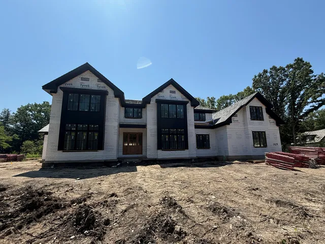 a view of a livingroom with wooden floor and a fireplace