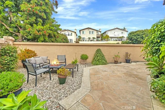 a view of a patio with table and chairs and potted plants