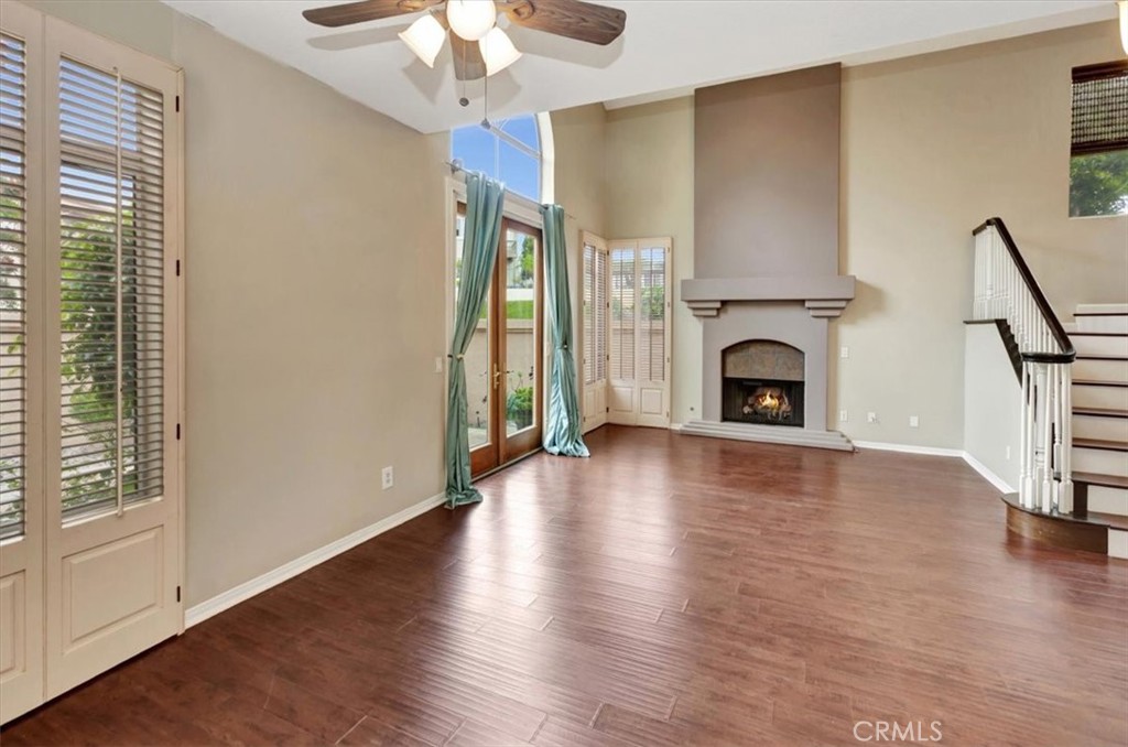 17 Marquesa Dana Point, CA 92629 - Photo 4 of 20 an empty room with wooden floor fireplace and windows