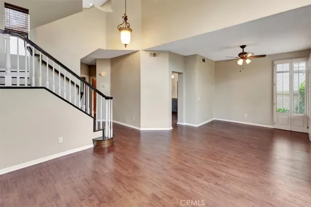 a view of a room with wooden floor and staircase