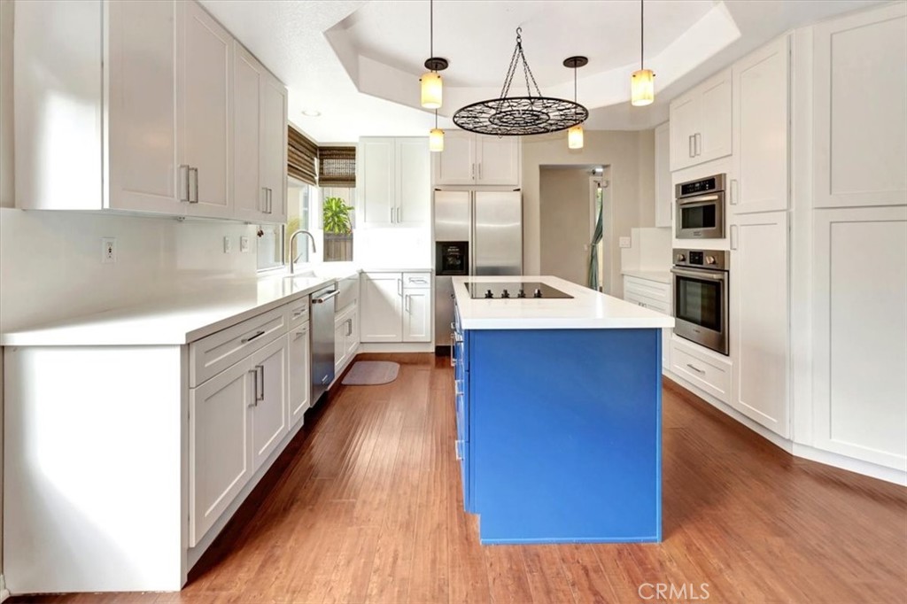 17 Marquesa Dana Point, CA 92629 - Photo 8 of 20 a large kitchen with stainless steel appliances a center island wooden floor and a window