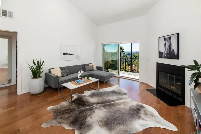 a living room with furniture wooden floor and a fireplace
