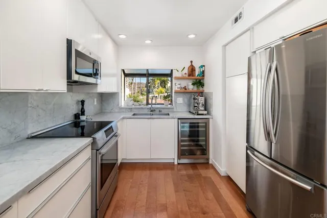 a kitchen with a refrigerator stove and sink