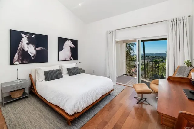 a bedroom with a bed and glass wall