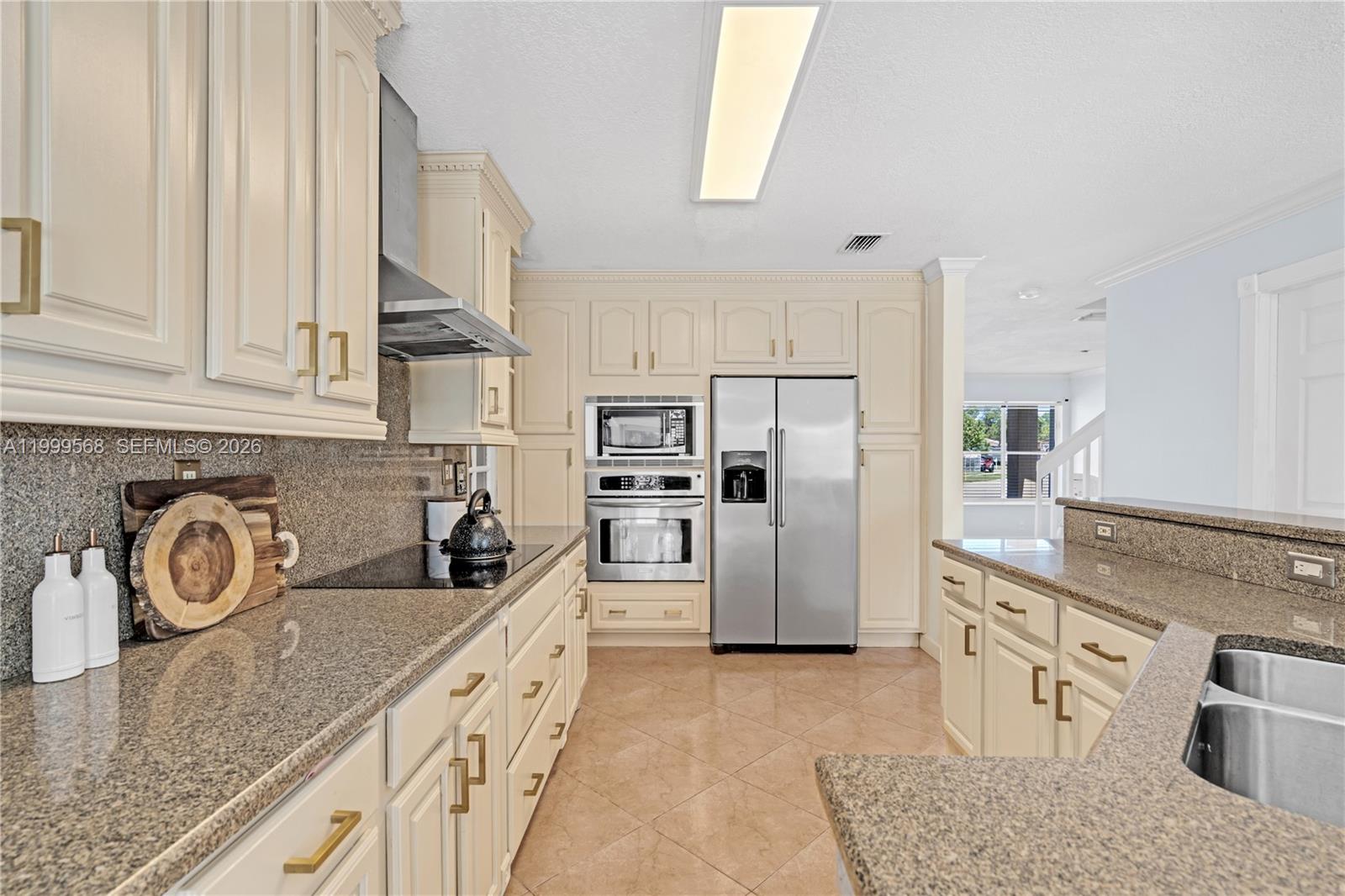 13790 Southwest 174th Street Miami, FL 33177 - Photo 14 of 41 a kitchen with stainless steel appliances granite countertop a sink and a refrigerator