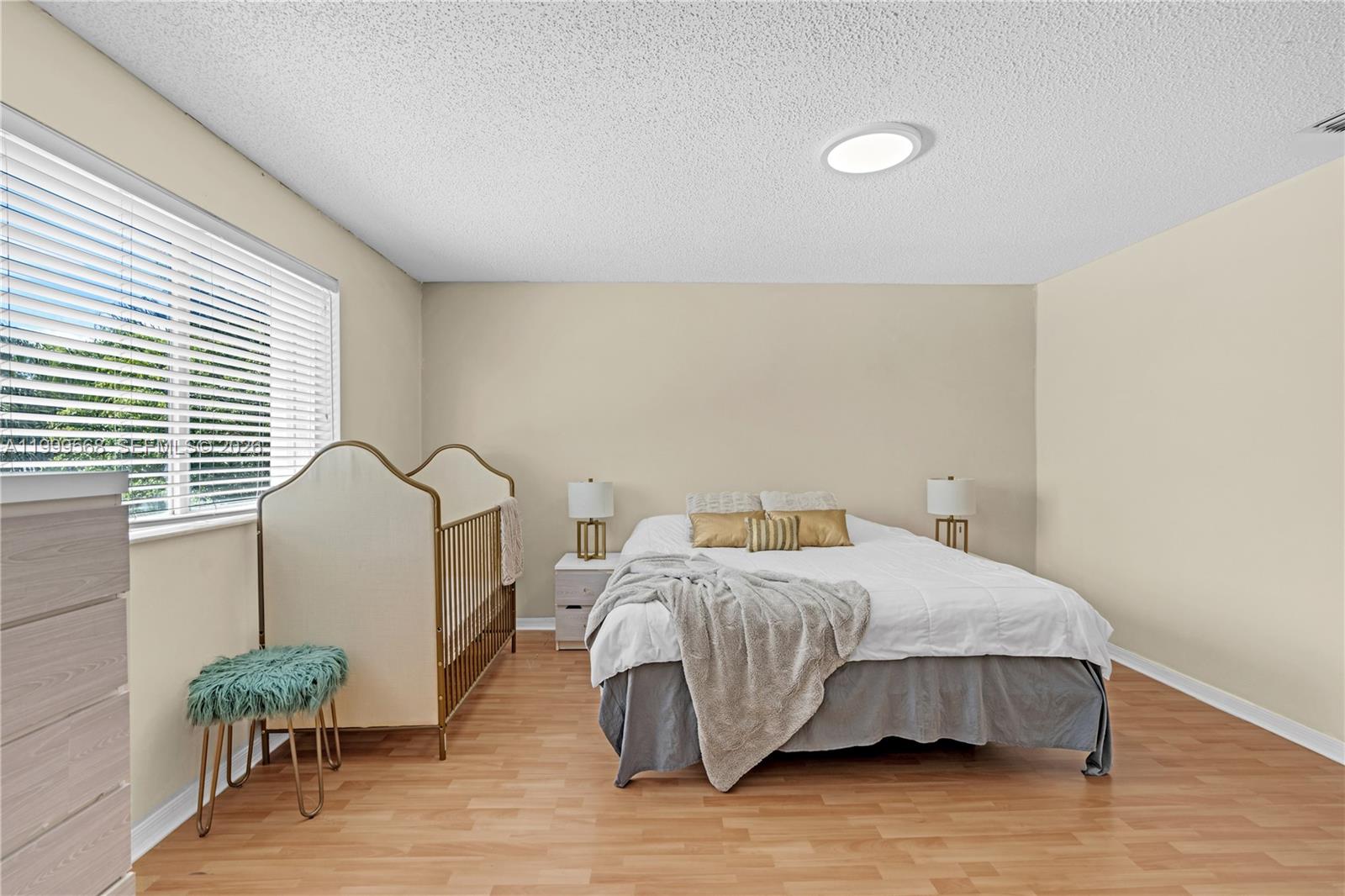 13790 Southwest 174th Street Miami, FL 33177 - Photo 19 of 41 a bedroom with a bed and a table