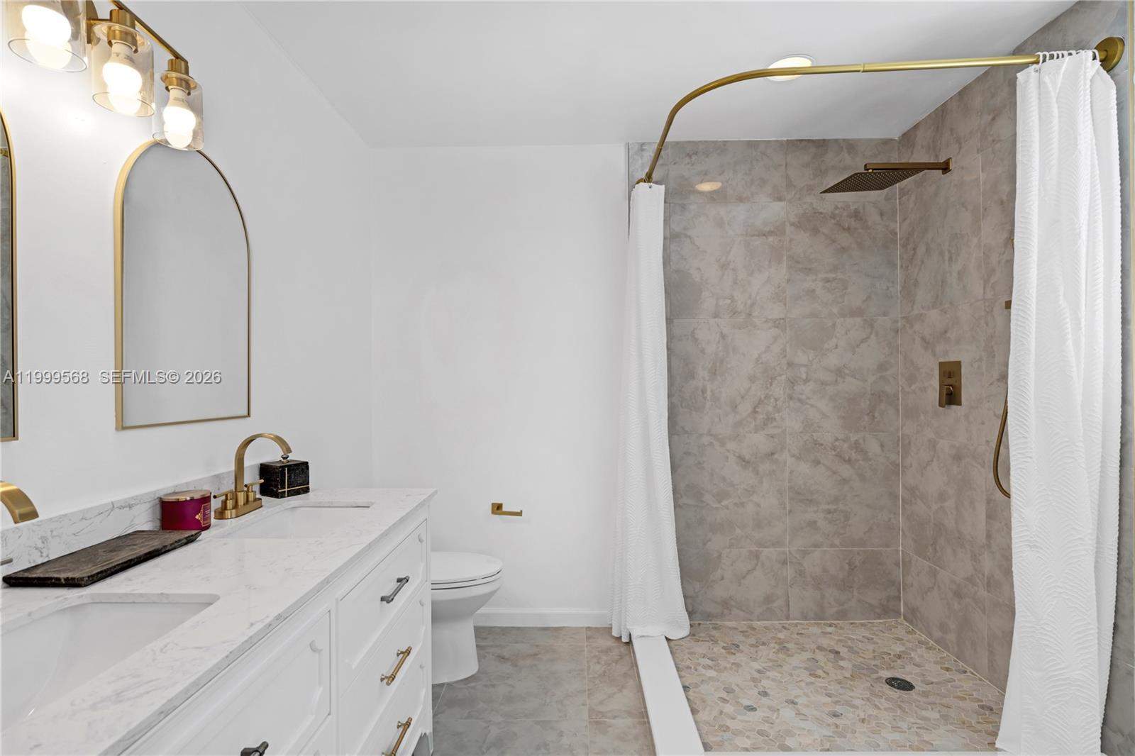 13790 Southwest 174th Street Miami, FL 33177 - Photo 20 of 41 a bathroom with a sink a mirror and a shower