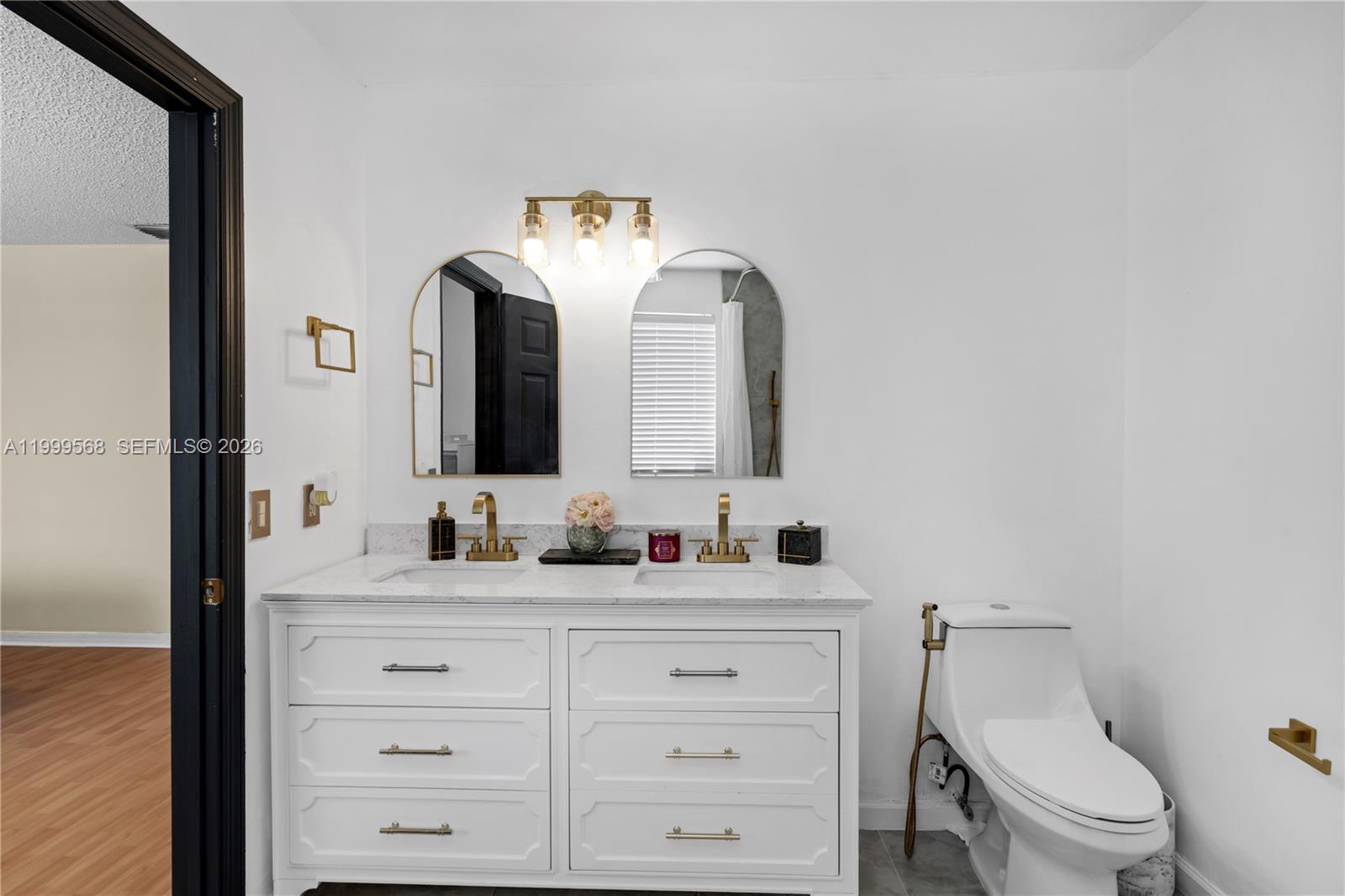 13790 Southwest 174th Street Miami, FL 33177 - Photo 21 of 41 a bathroom with a toilet a sink and mirror