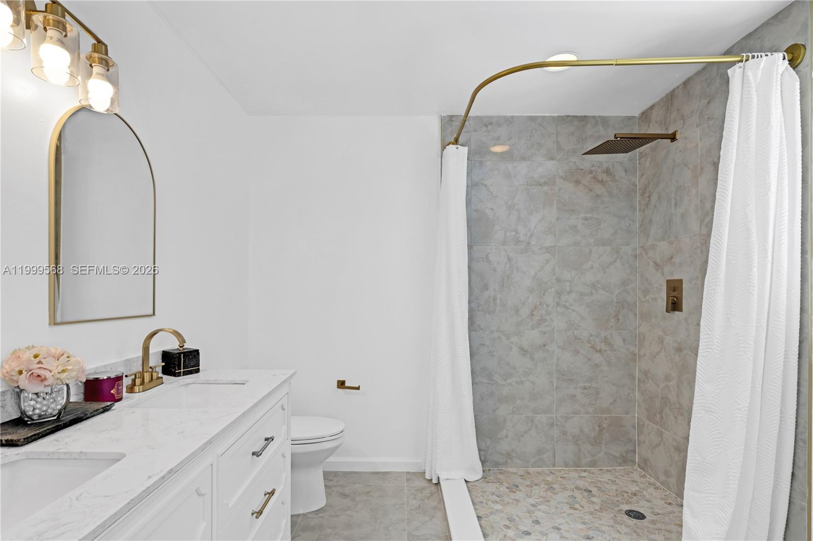 13790 Southwest 174th Street Miami, FL 33177 - Photo 22 of 41 a bathroom with a sink a toilet and shower
