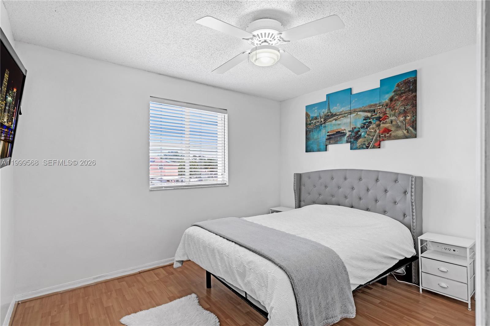 13790 Southwest 174th Street Miami, FL 33177 - Photo 24 of 41 a bedroom with a large bed and a chandelier