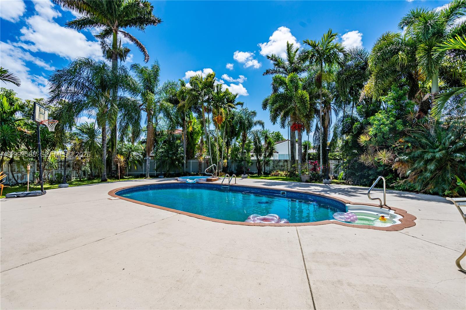 13790 Southwest 174th Street Miami, FL 33177 - Photo 28 of 41 a view of swimming pool with a yard and palm trees