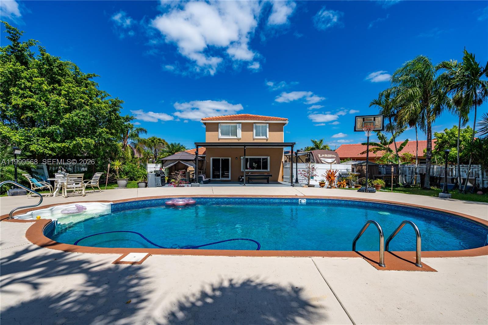 13790 Southwest 174th Street Miami, FL 33177 - Photo 31 of 41 a view of a swimming pool with a patio