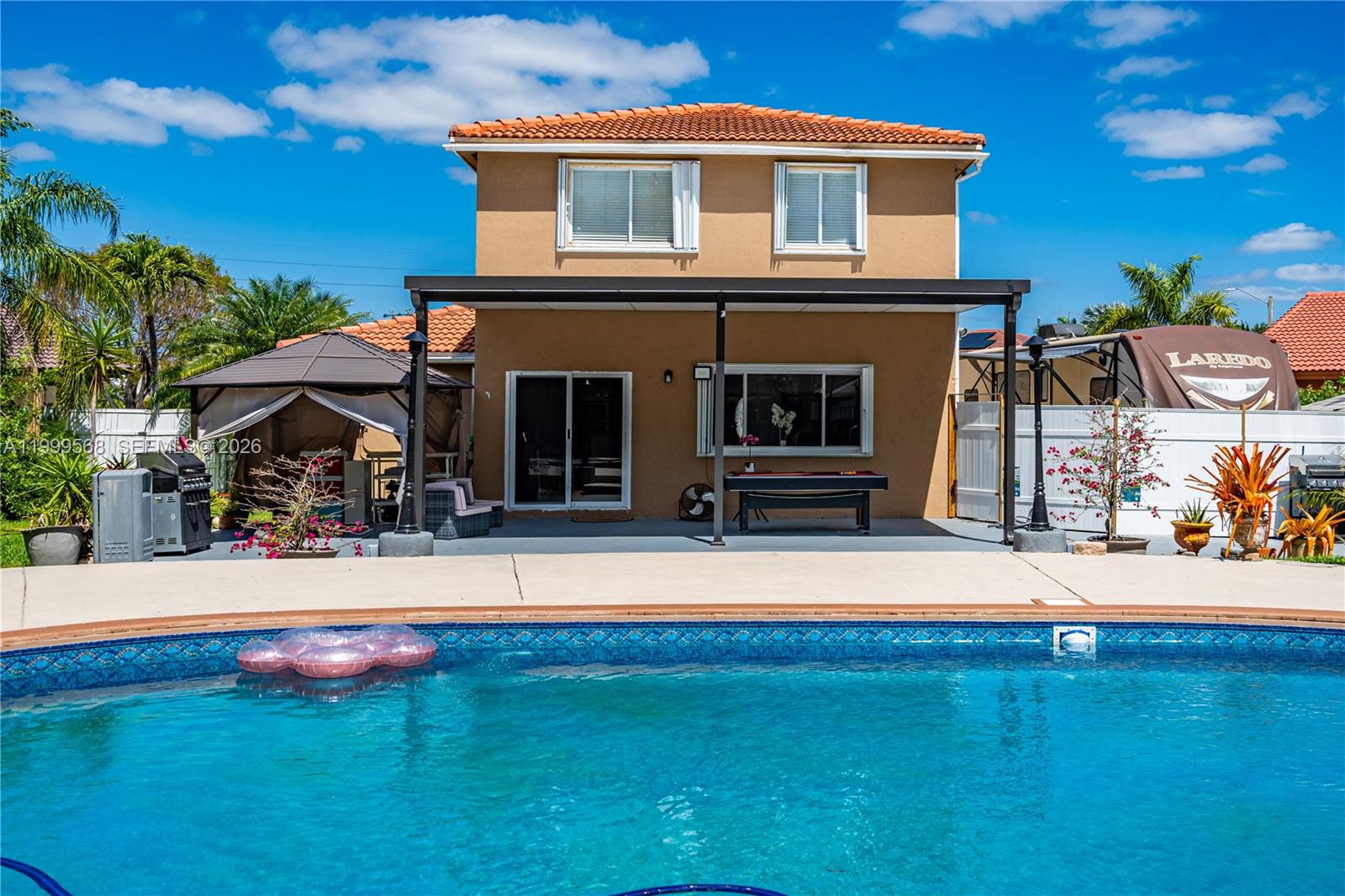 13790 Southwest 174th Street Miami, FL 33177 - Photo 32 of 41 a front view of a house with yard and furniture