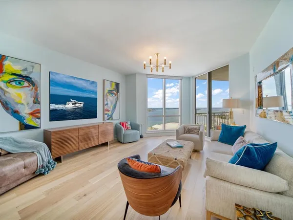 a living room with furniture and a floor to ceiling window