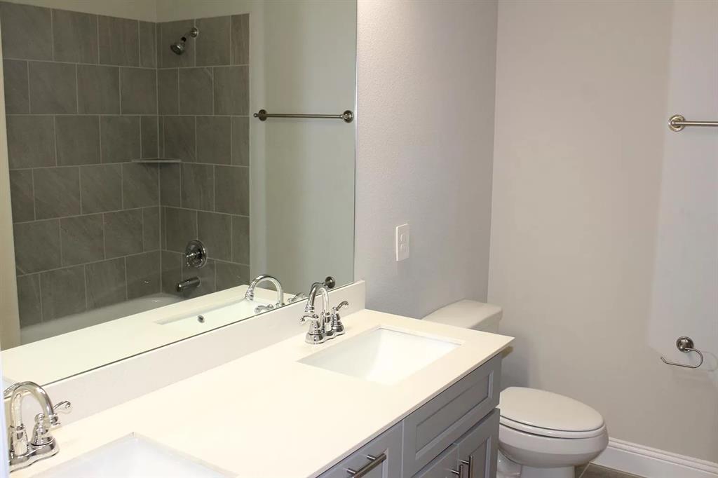 1752 Redding Street Allen, TX 75002 - Photo 20 of 24 Full bathroom with vanity, tiled shower / bath, and toilet