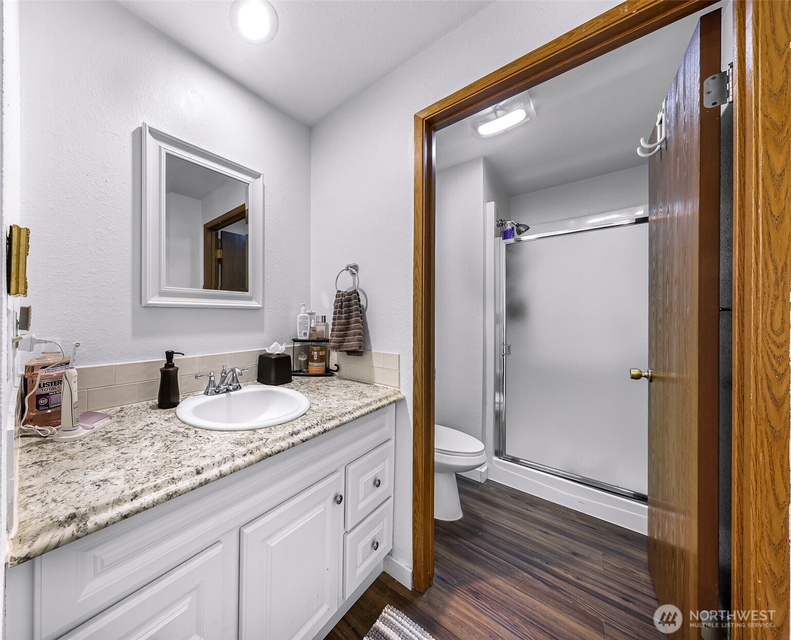 1730 Southwest 318th Place, Unit 39D Federal Way, WA 98023 - Photo 26 of 36 a bathroom with a granite countertop sink mirror and vanity