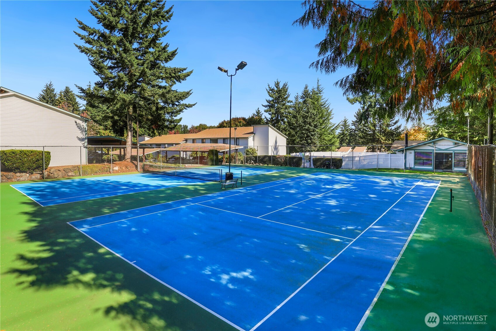 1730 Southwest 318th Place, Unit 39D Federal Way, WA 98023 - Photo 30 of 36 a view of a tennis ground with large trees
