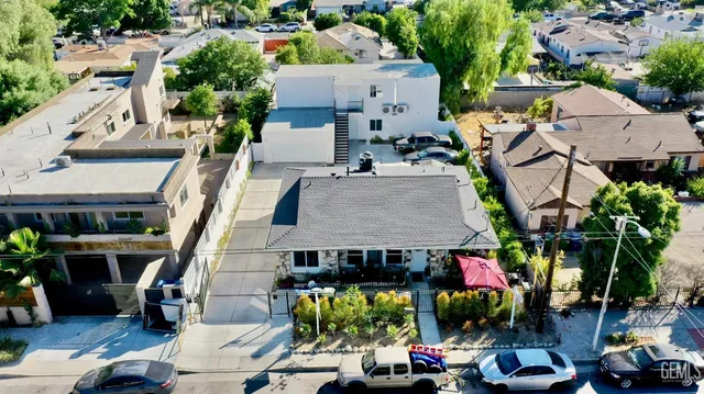 an aerial view of multiple houses with a yard
