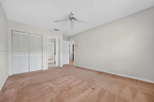 an aerial view of a house with a yard and lake view
