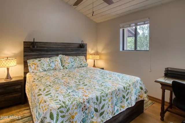 a bed sitting in a bedroom next to a window