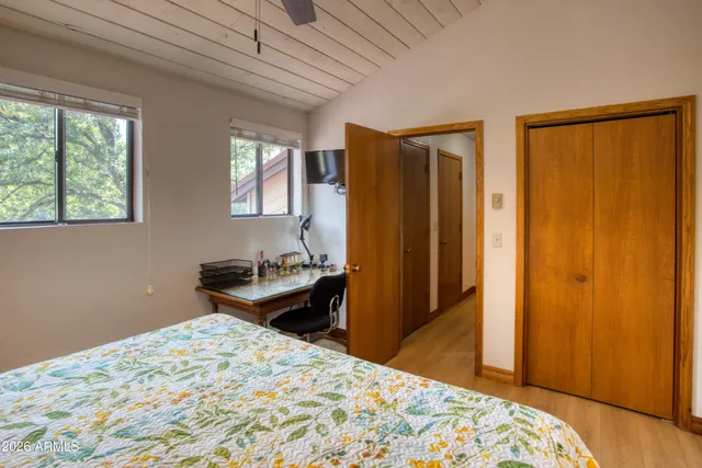 a bedroom with a bed and wooden floor