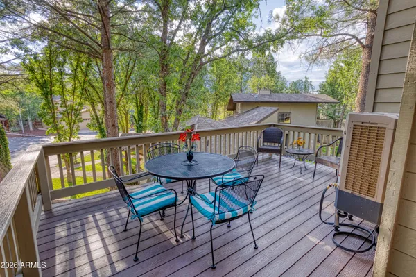 a view of a chairs and table on the deck