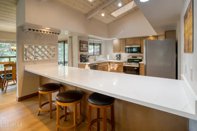 a large kitchen with a table and chairs