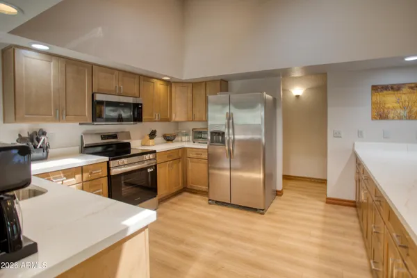 a kitchen with a refrigerator a stove top oven a sink and dishwasher