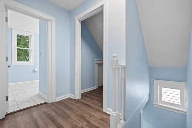 a view of a house with a yard and large tree