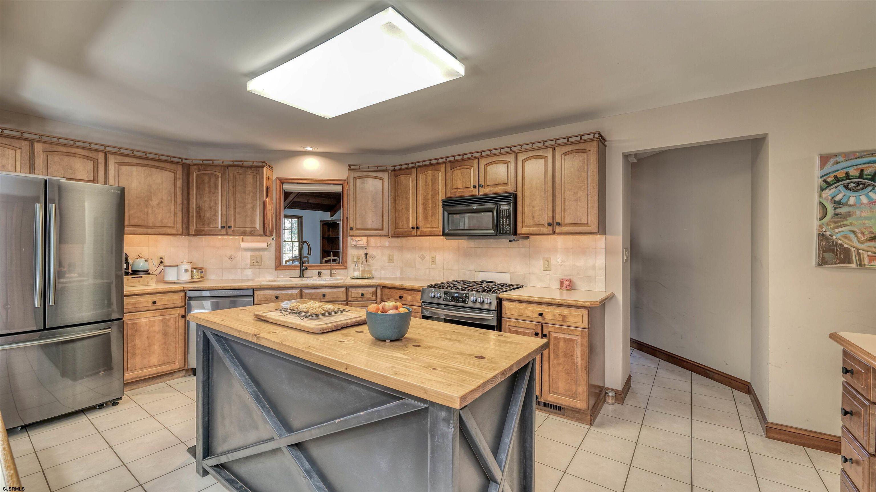 3 School House Road Egg Harbor Township, NJ 08234 - Photo 11 of 56 a kitchen with a sink a stove a refrigerator cabinets and a dining table