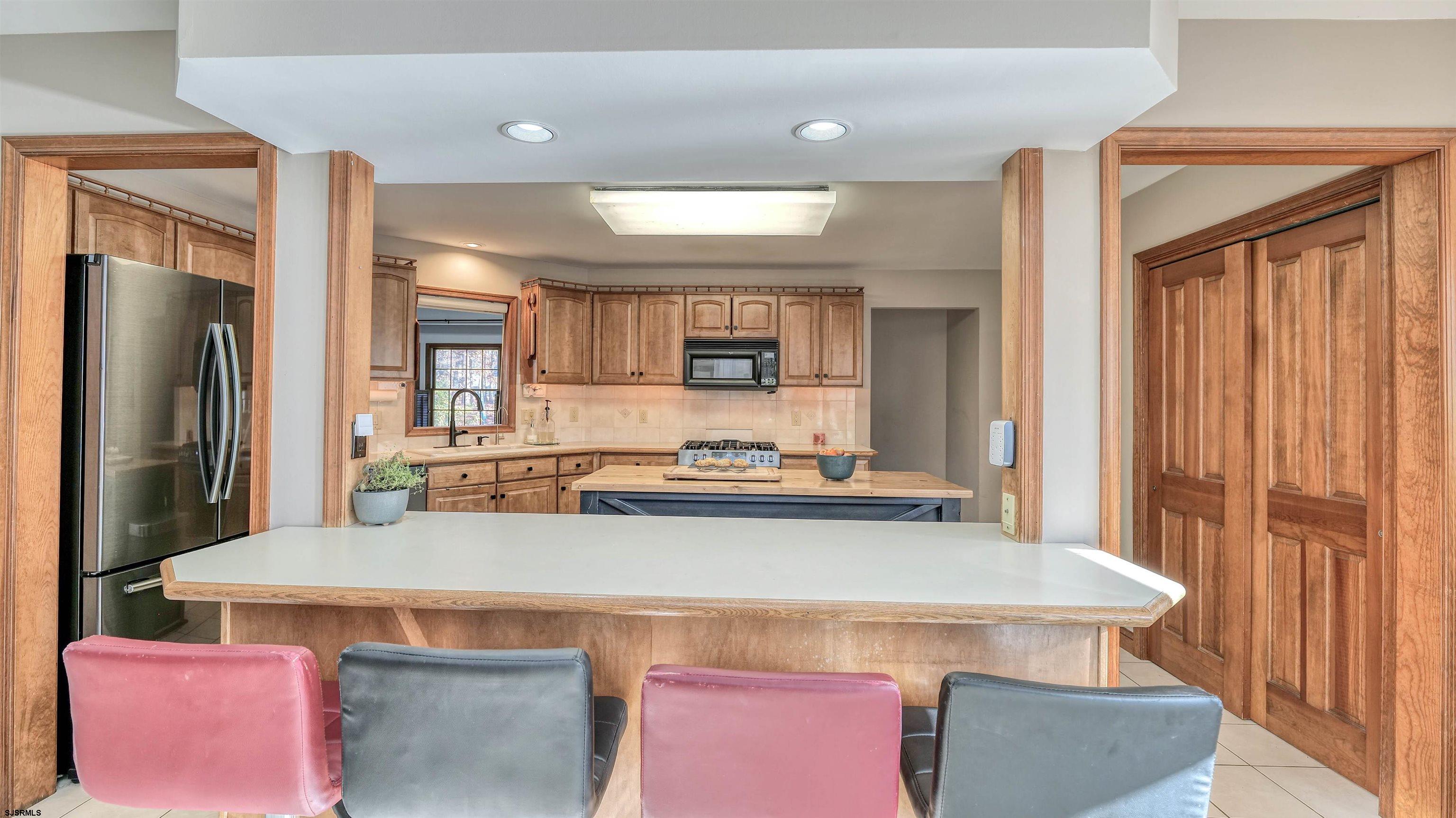 3 School House Road Egg Harbor Township, NJ 08234 - Photo 14 of 56 a kitchen with a stove a sink and a refrigerator
