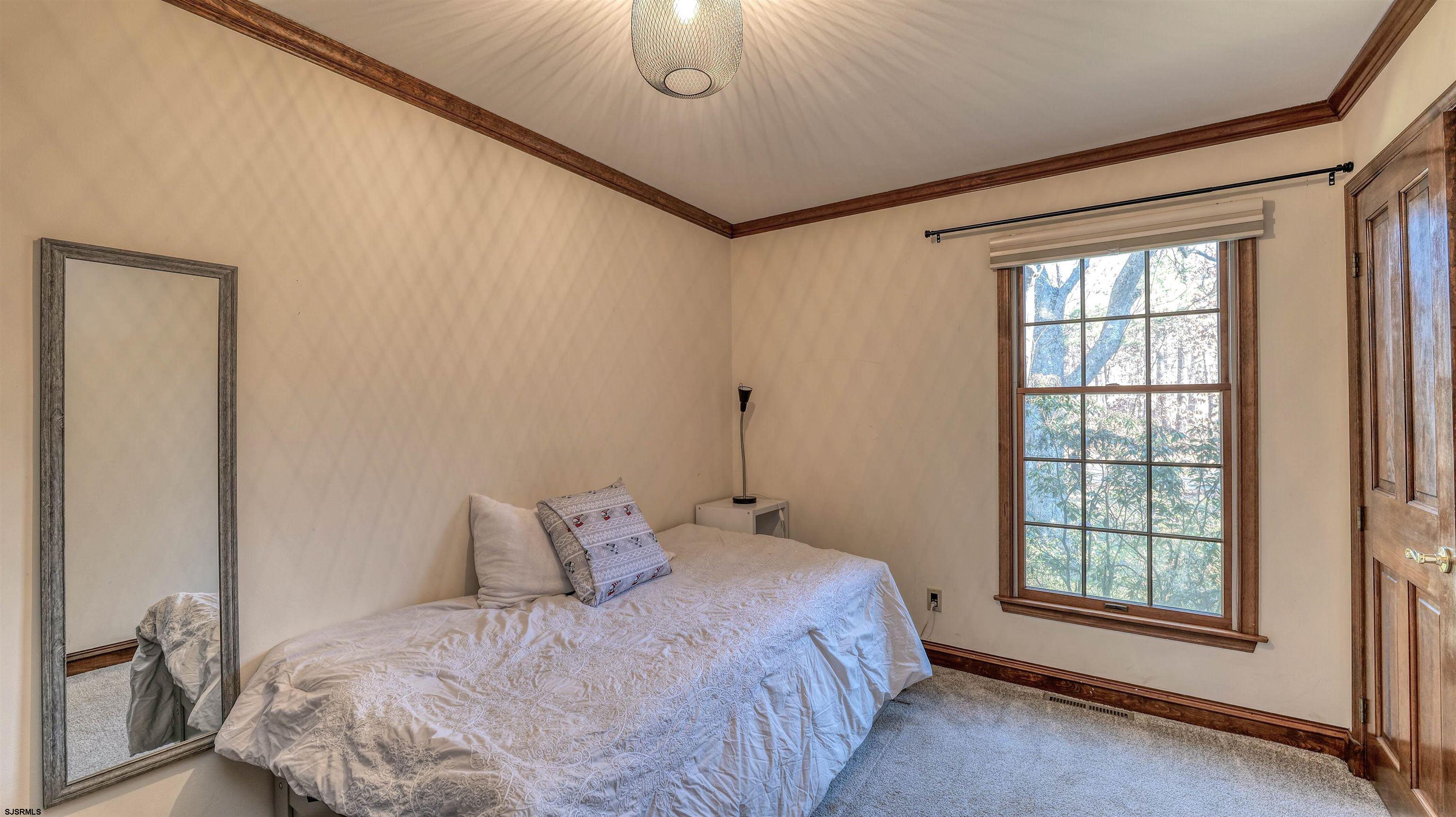 3 School House Road Egg Harbor Township, NJ 08234 - Photo 22 of 56 a bed sitting in a bedroom next to a window
