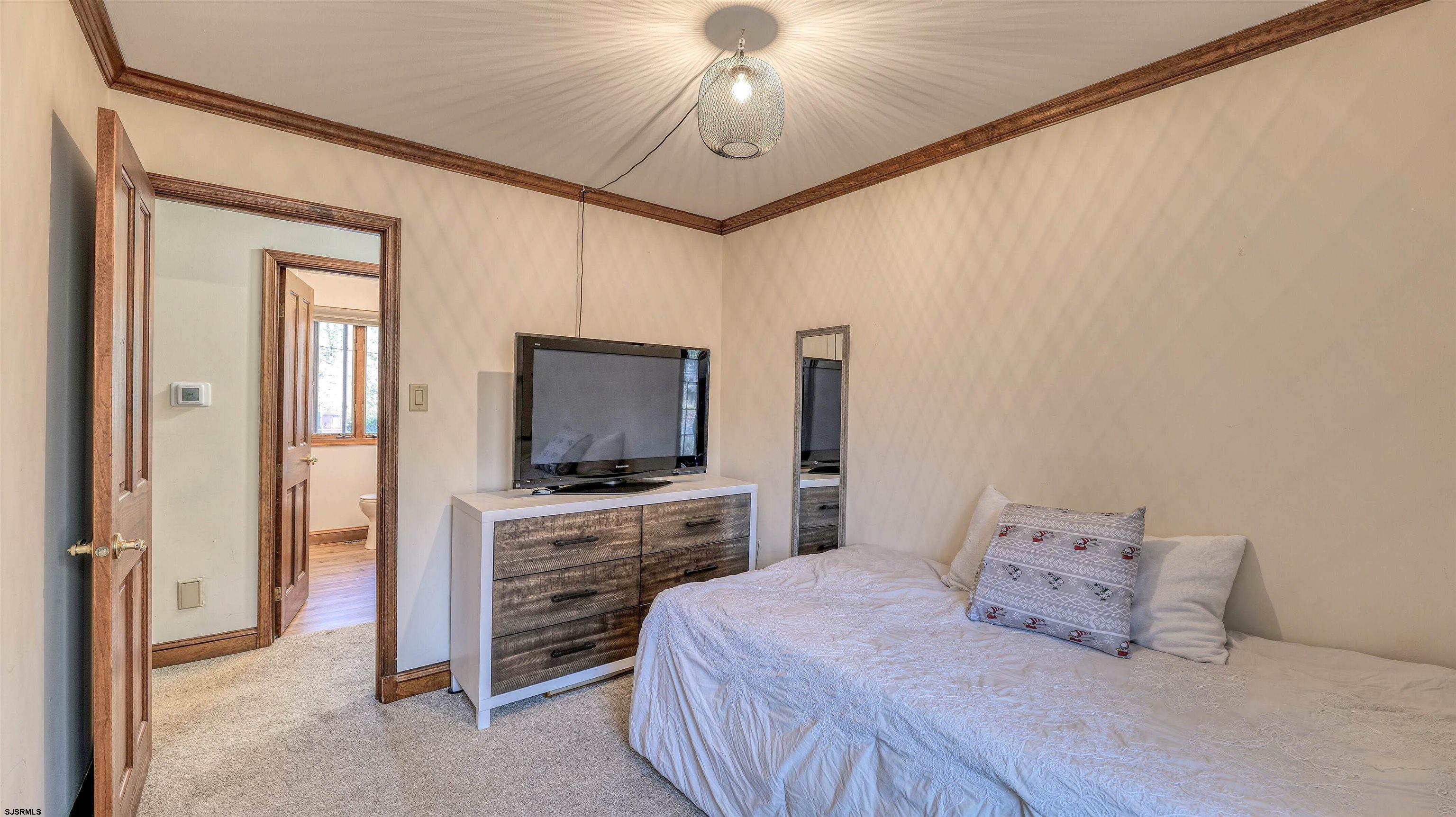 3 School House Road Egg Harbor Township, NJ 08234 - Photo 23 of 56 a bedroom with a bed and a flat screen tv