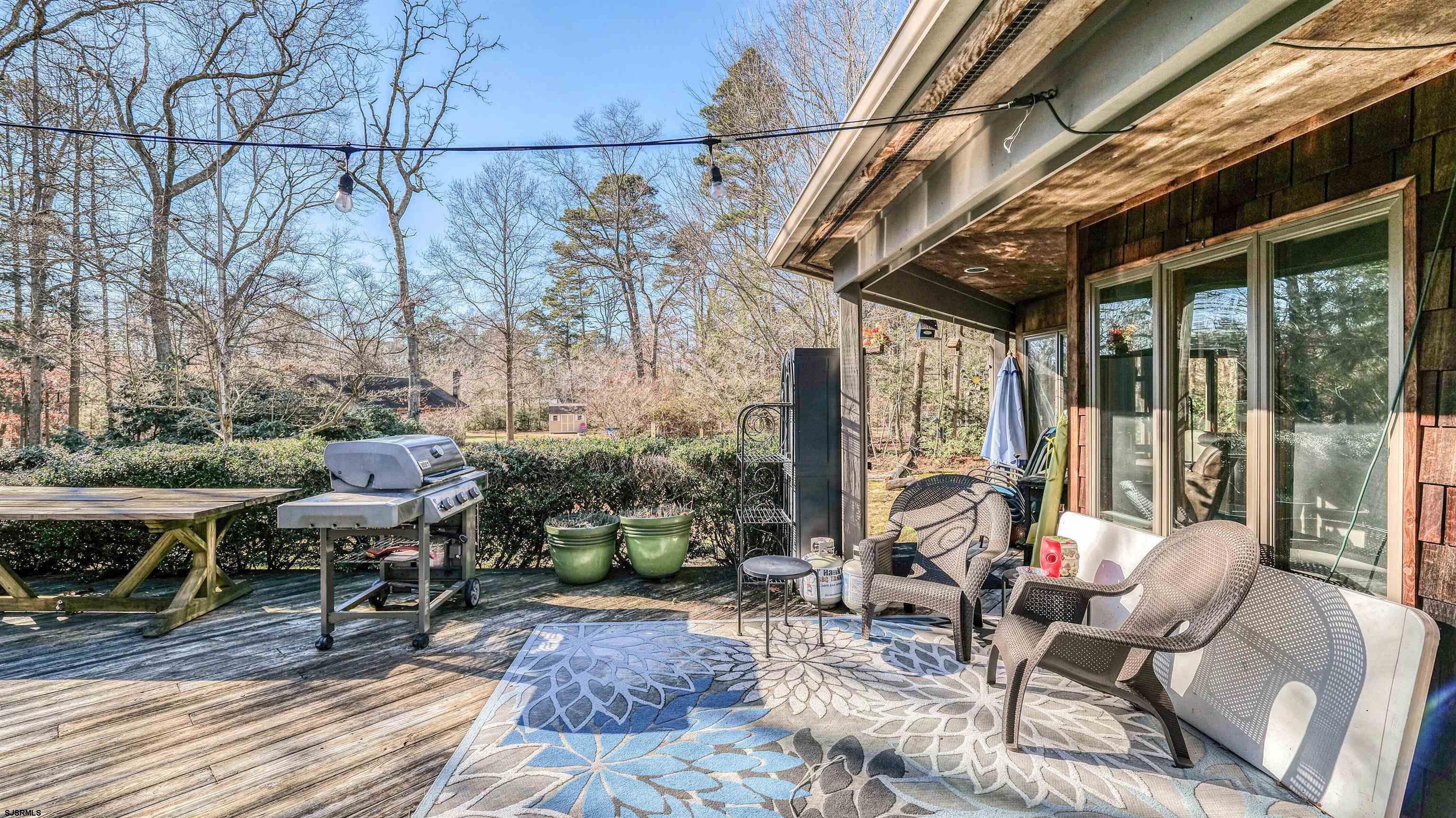3 School House Road Egg Harbor Township, NJ 08234 - Photo 34 of 56 a view of a patio with table and chairs and potted plants