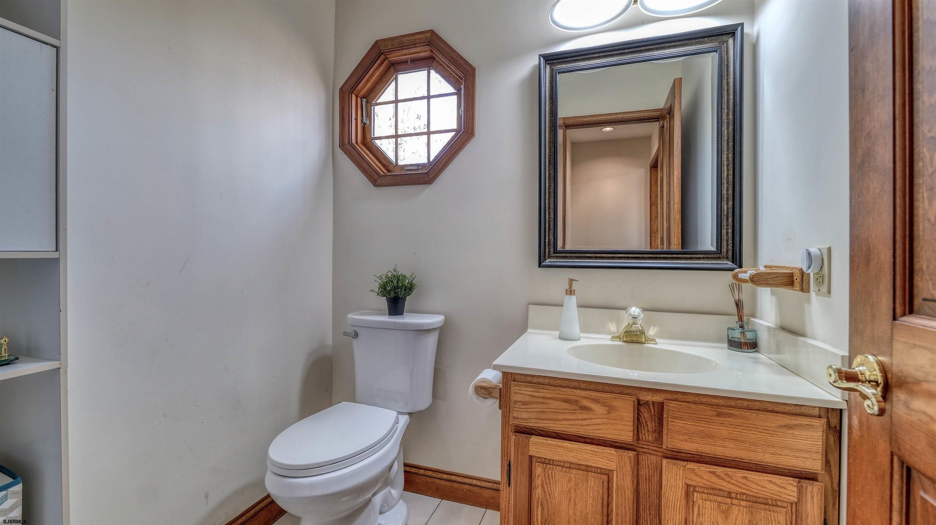3 School House Road Egg Harbor Township, NJ 08234 - Photo 7 of 56 a bathroom with a toilet a sink a vanity and mirror