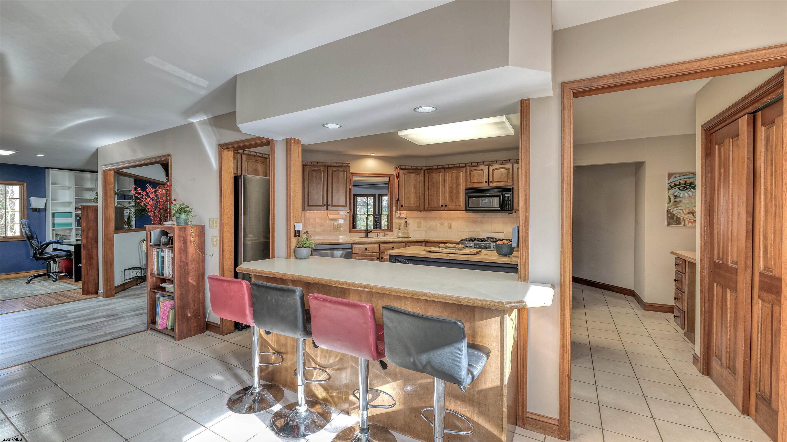 3 School House Road Egg Harbor Township, NJ 08234 - Photo 10 of 56 a kitchen with stainless steel appliances kitchen island granite countertop a refrigerator and cabinets