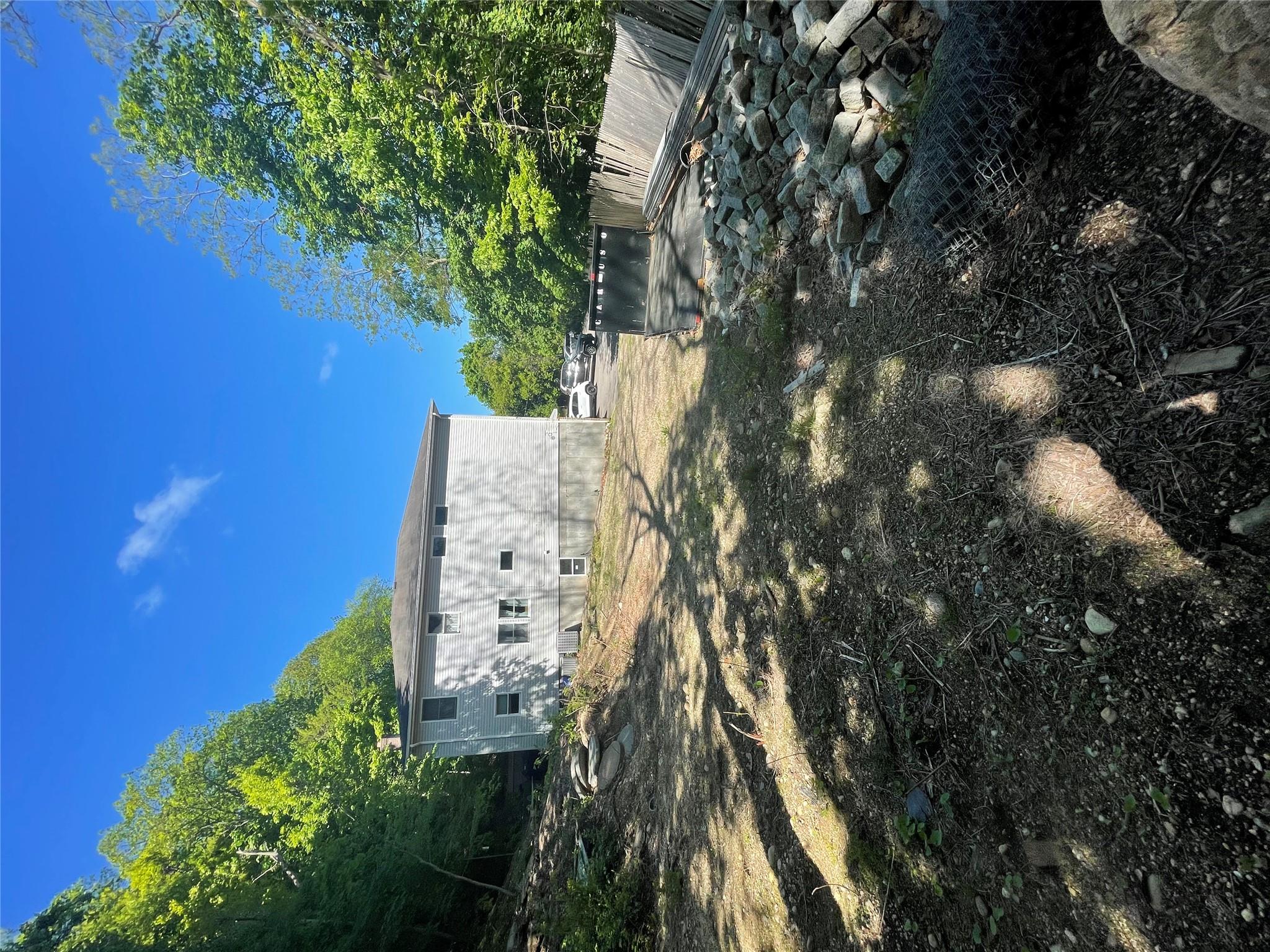 Long Branch Road Glen Cove, NY 11542 - Photo 2 of 3 a view of a house with a yard