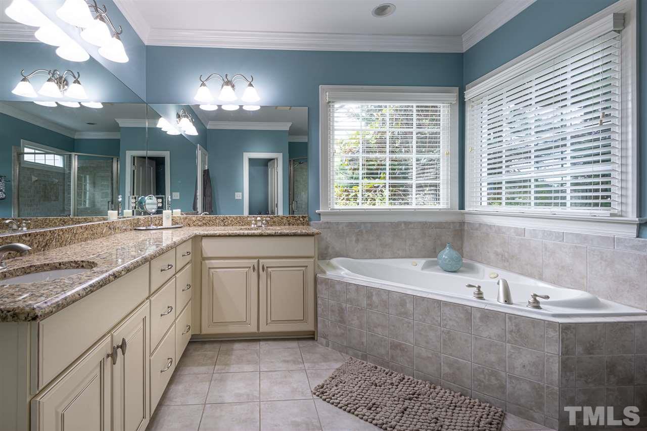 2916 SnapsWell Street Raleigh, NC 27614 - Photo 17 of 30 Abundant Natural Light and Elongated L-Shaped Granite Counter Tops with Separated Dual Vanities.