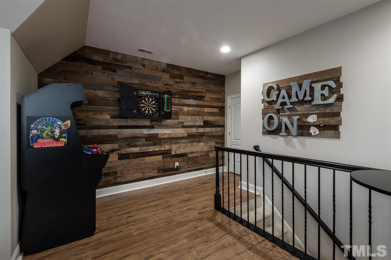 2916 SnapsWell Street Raleigh, NC 27614 - Photo 20 of 30 Get Your Best "Game On". Up the Back Staircase and Treat your Guests in this Large Bonus Room with the Reclaimed Wood Wall. It's Game Time...