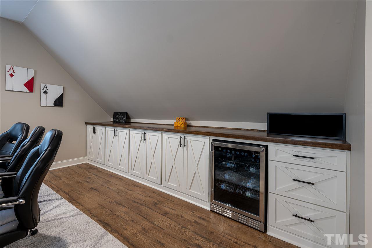 2916 SnapsWell Street Raleigh, NC 27614 - Photo 21 of 30 Beautiful Custom Built Bank of Cabinetry Space for Crafts, Games, Toys and/or Work Out Equipment ! Boasts of a Gorgeous Solid Wood Top finished to Perfection with Impressive Hardware.
