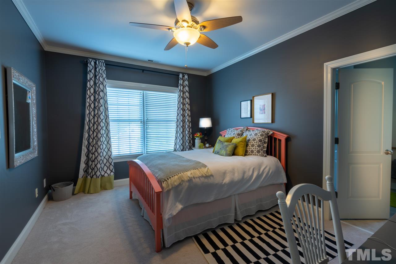 2916 SnapsWell Street Raleigh, NC 27614 - Photo 25 of 30 Back Left Guest Suite Offers a View of the Backyard, Ceiling Fan, Full Bathroom & Walk In Closet that has Access to Another Attic Storage Area with Approximately 110 sf.