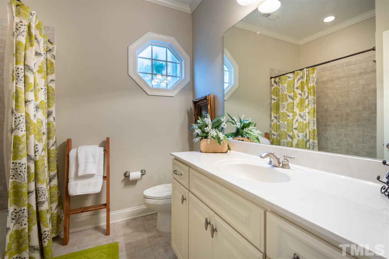 2916 SnapsWell Street Raleigh, NC 27614 - Photo 26 of 30 Convenient Space in this Guest Suite Spa Complete with a Charming Port Hole Window ! Large Cabinet with Single Vanity and Elongated Counter Top.