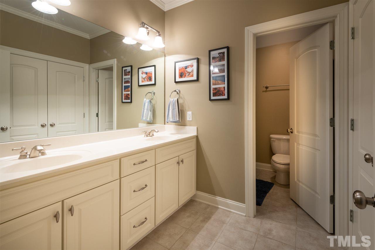 2916 SnapsWell Street Raleigh, NC 27614 - Photo 27 of 30 Abundant Counter Top on this Convenient Dual Vanity and lots of Cabinet Storage and Drawers for Ease of Getting that Morning Started and Out the Door. Smart Split Design with Door to Shower/Tub and Toilet.