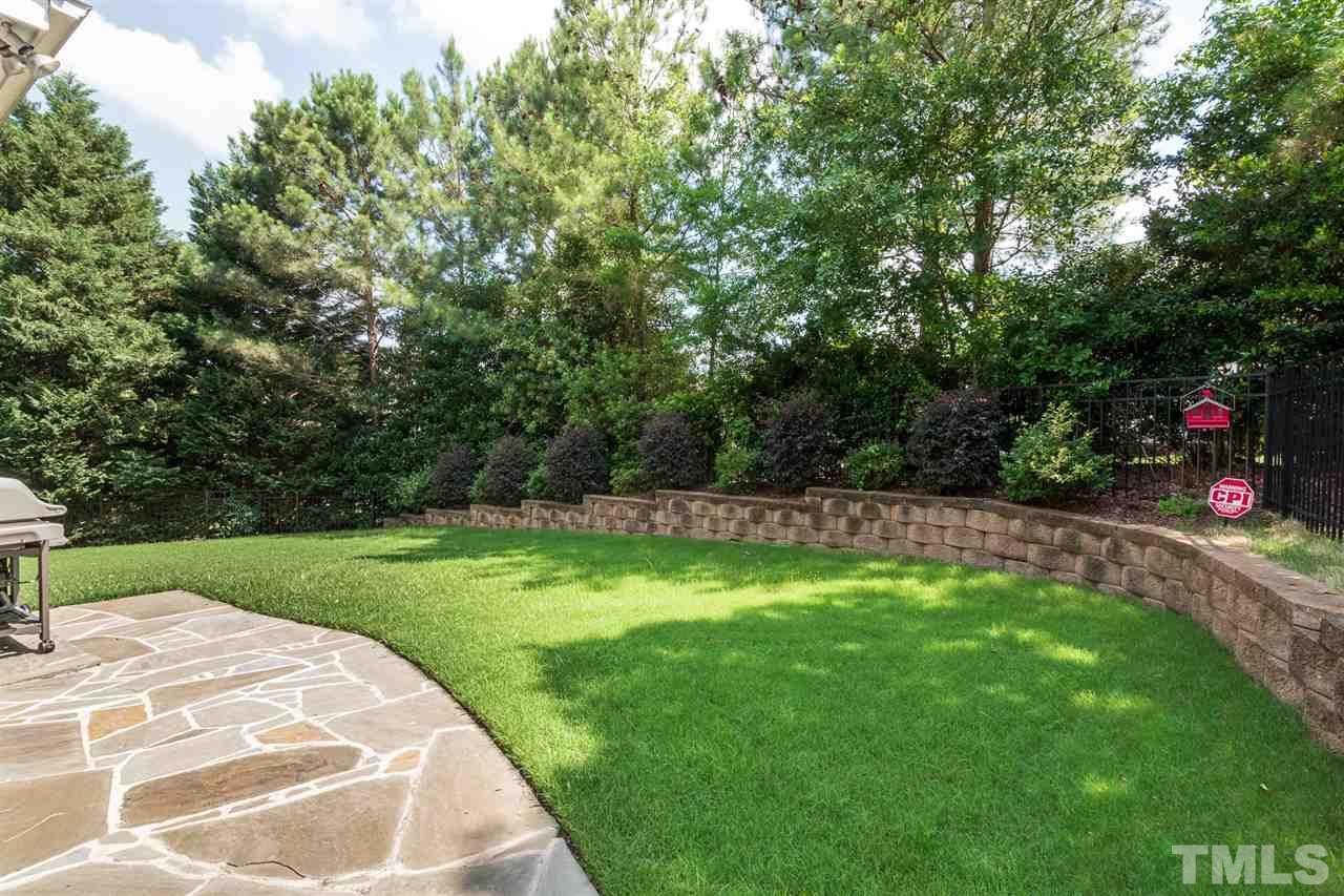 2916 SnapsWell Street Raleigh, NC 27614 - Photo 30 of 30 Take in this Fenced Backyard on the Stone Patio and Enjoy A Day in the Sun and Feet on the Zoysia Grass bordered with this Custom Stone Ledge & Privacy Landscaping.