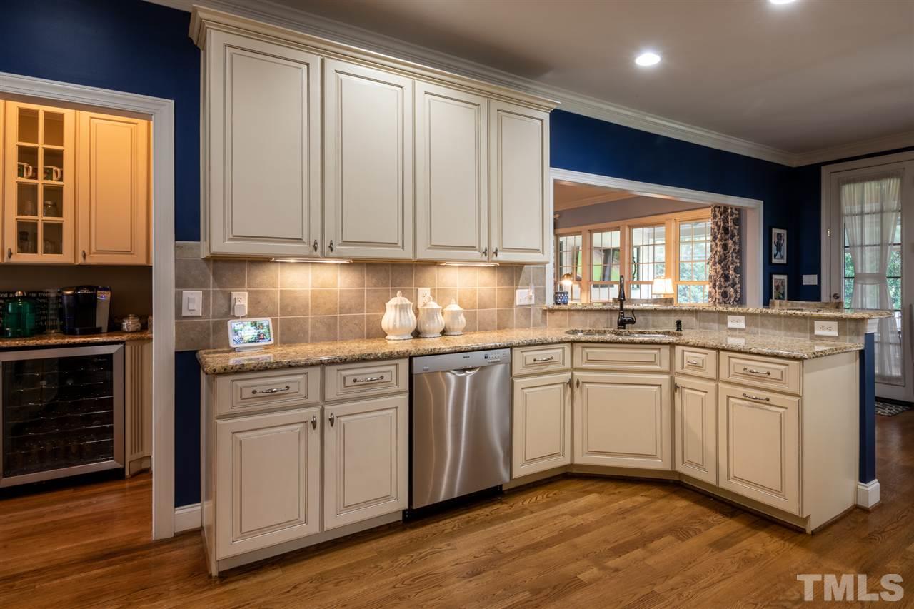 2916 SnapsWell Street Raleigh, NC 27614 - Photo 7 of 30 View of Sink and Raised Top Stool Bar. PLUS Butler's Pantry Complete with Wine Fridge and More Storage for Special Dishware. Convenient for Entertaining just off the Kitchen !