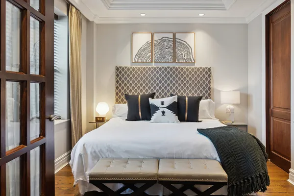 a bedroom with a bed and wooden floor