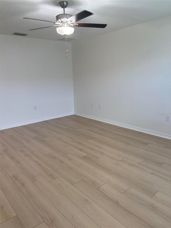 14442 Editors Note Street Ruskin, FL 33573 - Photo 18 of 31 a view of a chandelier fan and hardwood floor