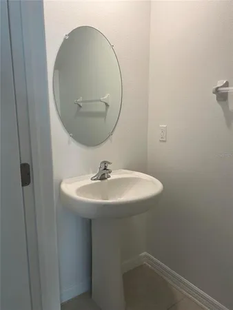 a bathroom with a sink and mirror