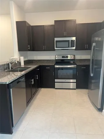 a kitchen with a sink stove and microwave